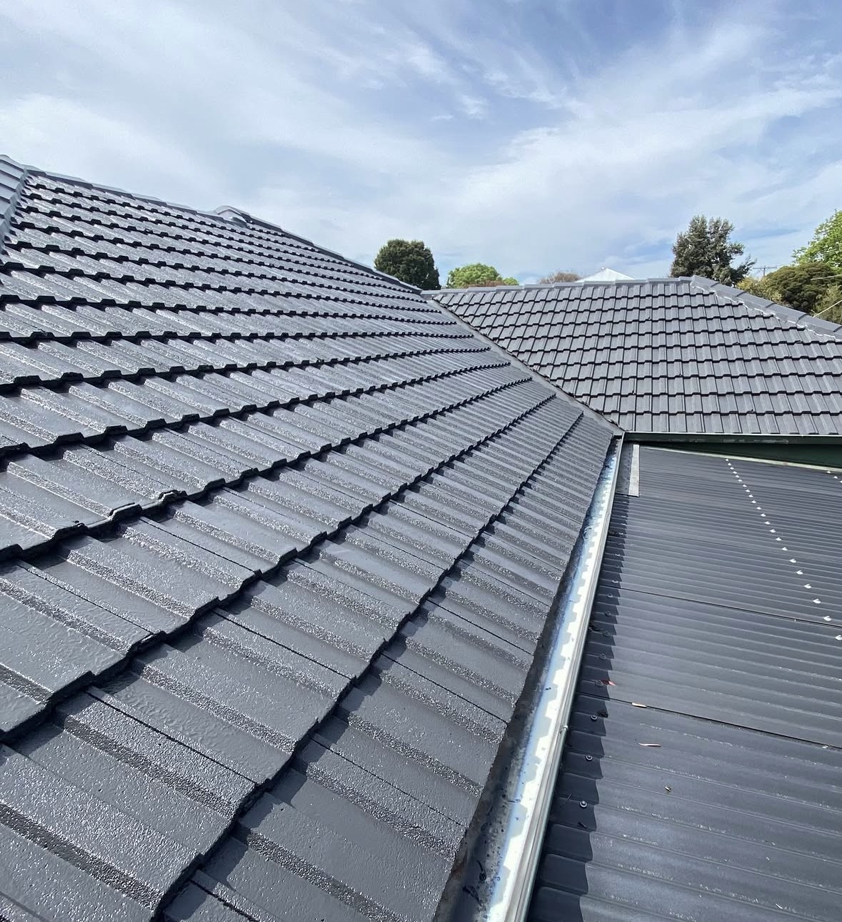 Restored charcoal tiles and roof junctions in Frankston South